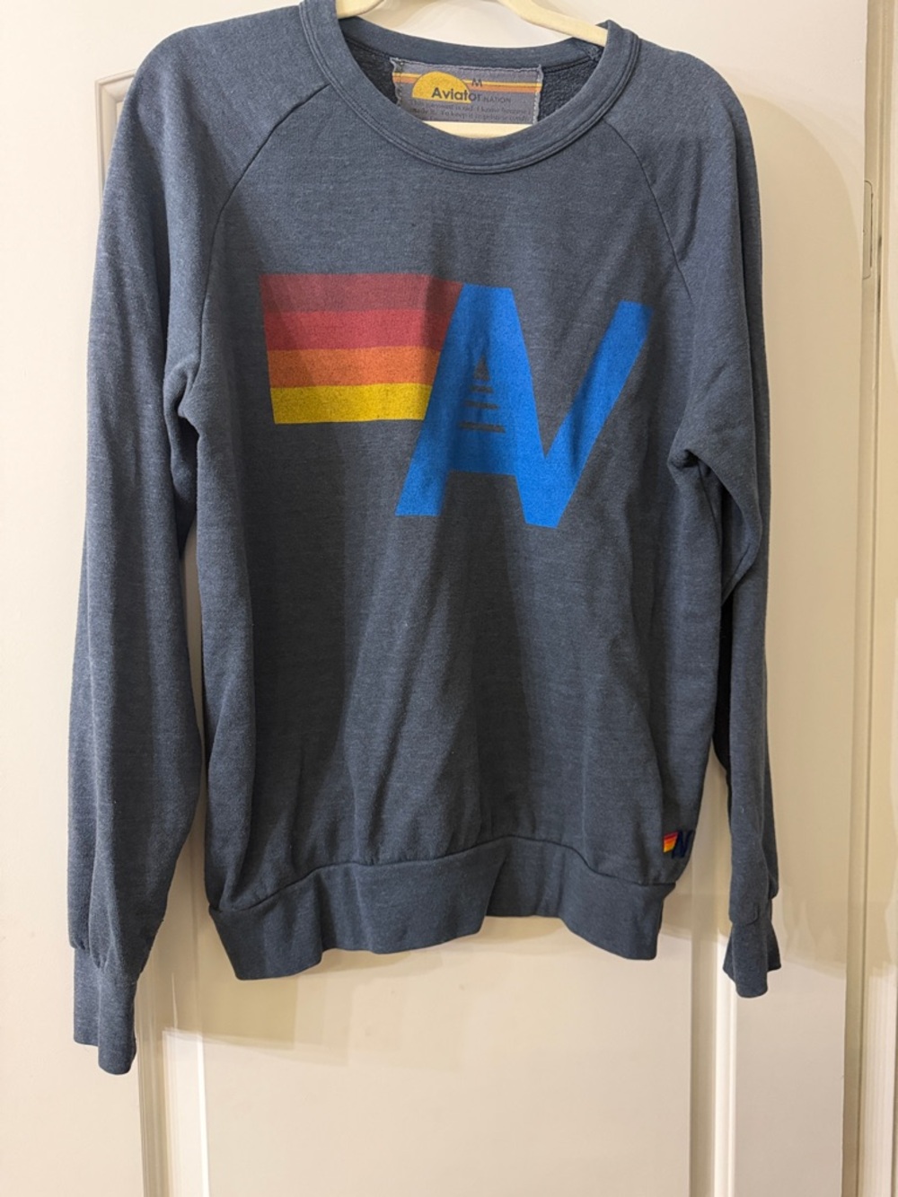 Aviator Nation Slate Blue Crewneck with Blue 'A' and Red-Orange-Yellow Stripes